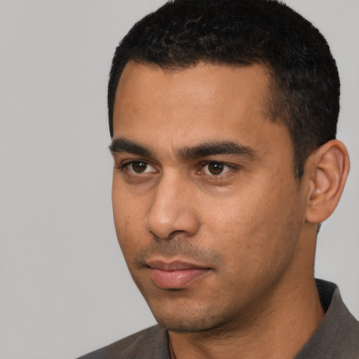 Neutral latino young-adult male with short  black hair and brown eyes