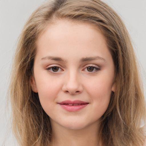 Joyful white child female with long  brown hair and brown eyes