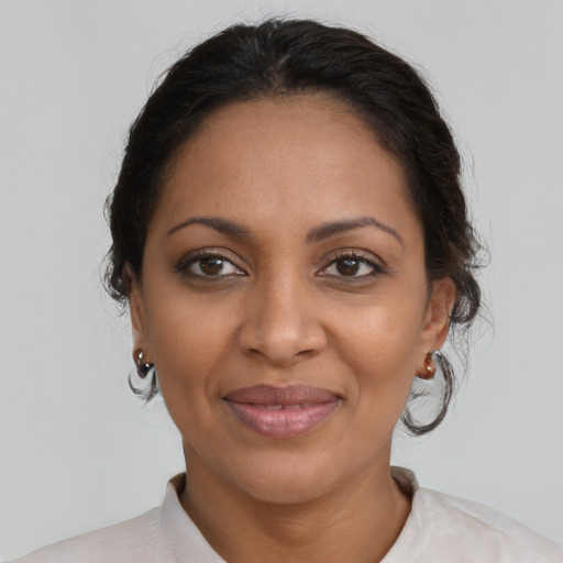 Joyful black adult female with medium  brown hair and brown eyes