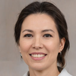 Joyful white adult female with medium  brown hair and brown eyes