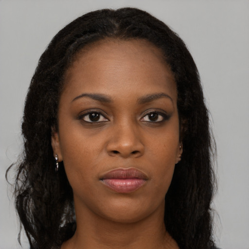Neutral black young-adult female with long  brown hair and brown eyes