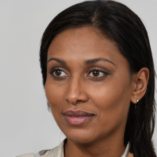 Joyful black young-adult female with medium  brown hair and brown eyes
