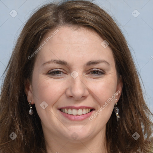 Joyful white adult female with long  brown hair and grey eyes