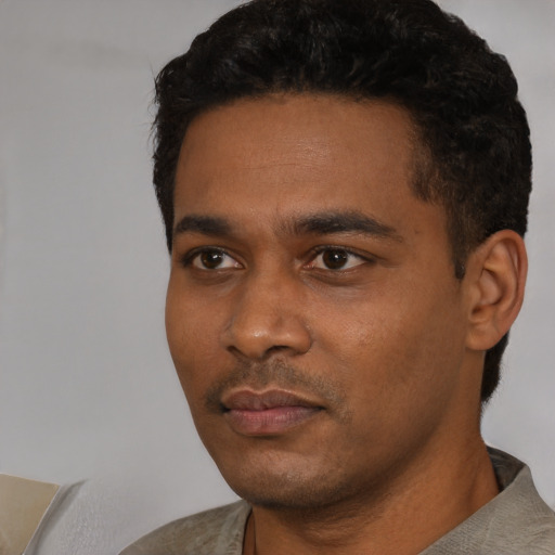 Neutral black young-adult male with short  black hair and brown eyes