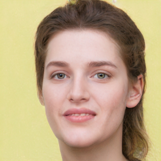 Joyful white young-adult female with long  brown hair and green eyes