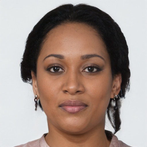 Joyful black young-adult female with medium  black hair and brown eyes