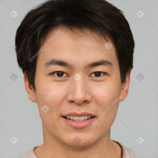 Joyful asian young-adult male with short  brown hair and brown eyes