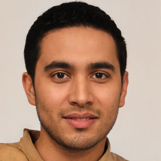 Joyful latino young-adult male with short  black hair and brown eyes