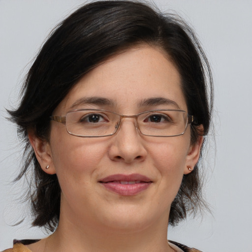 Joyful white adult female with medium  brown hair and brown eyes