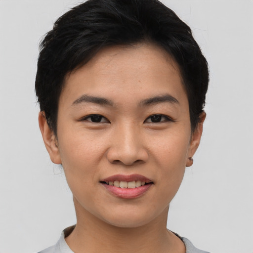 Joyful asian young-adult female with short  black hair and brown eyes