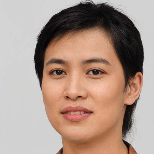 Joyful asian young-adult female with short  brown hair and brown eyes