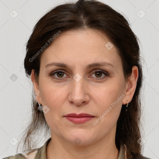 Joyful white adult female with medium  brown hair and brown eyes