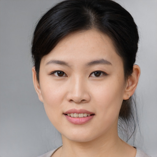 Joyful asian young-adult female with medium  brown hair and brown eyes