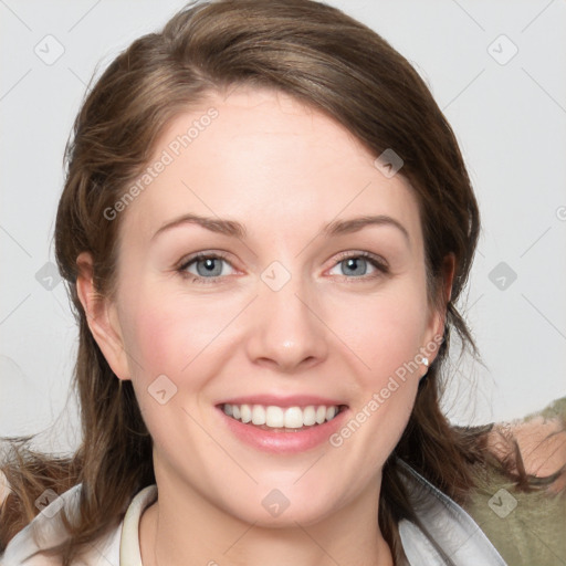 Joyful white young-adult female with medium  brown hair and blue eyes