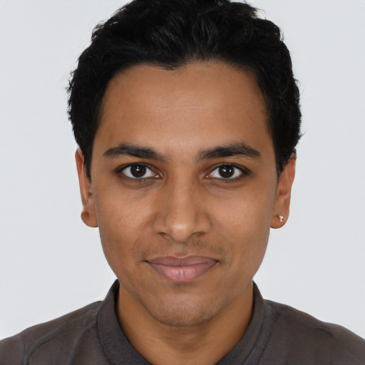Joyful latino young-adult male with short  black hair and brown eyes