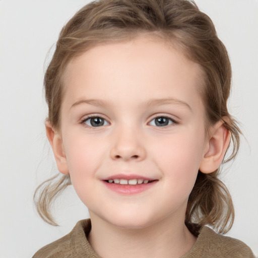 Joyful white child female with medium  brown hair and grey eyes