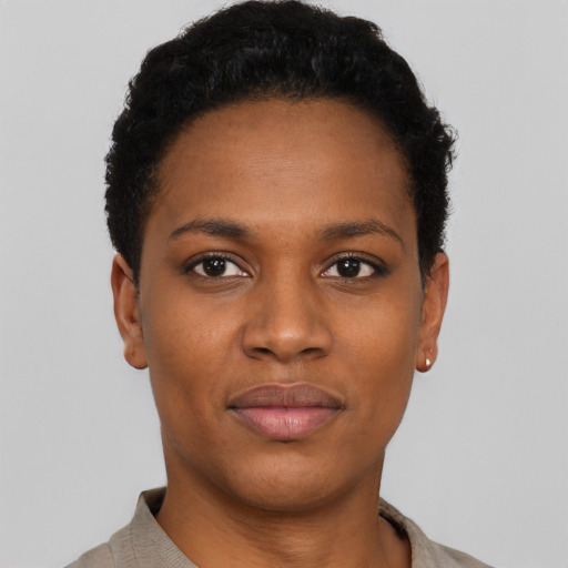 Joyful black young-adult female with short  black hair and brown eyes