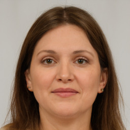 Joyful white adult female with long  brown hair and brown eyes