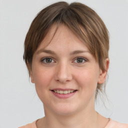 Joyful white young-adult female with medium  brown hair and grey eyes