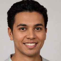 Joyful latino young-adult male with short  brown hair and brown eyes