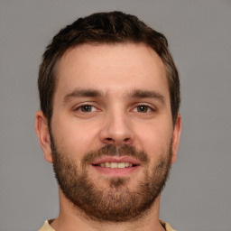 Joyful white young-adult male with short  brown hair and brown eyes