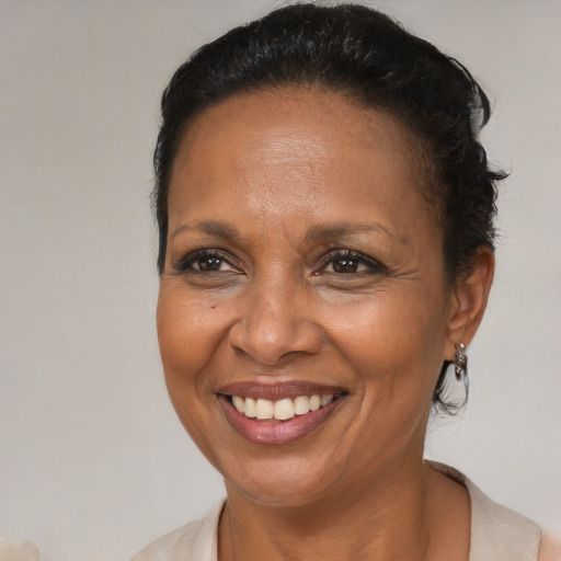 Joyful black adult female with medium  brown hair and brown eyes
