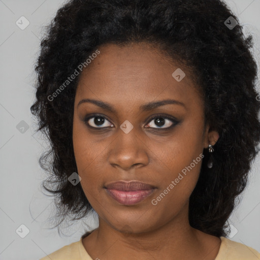 Joyful black young-adult female with long  black hair and brown eyes