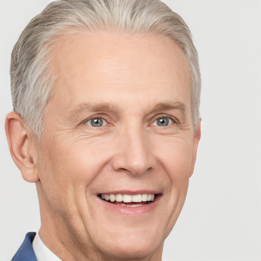 Joyful white middle-aged male with short  gray hair and blue eyes