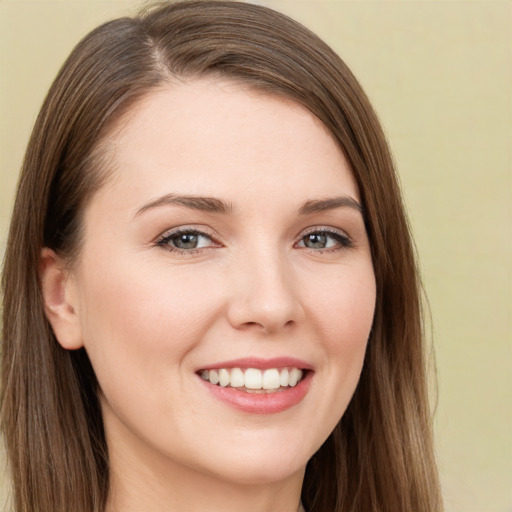 Joyful white young-adult female with long  brown hair and brown eyes