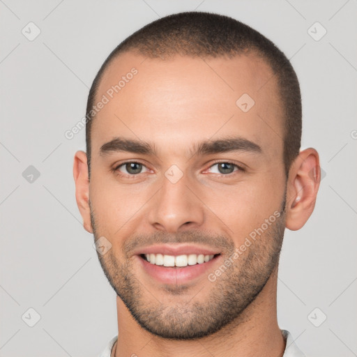 Joyful white young-adult male with short  brown hair and brown eyes