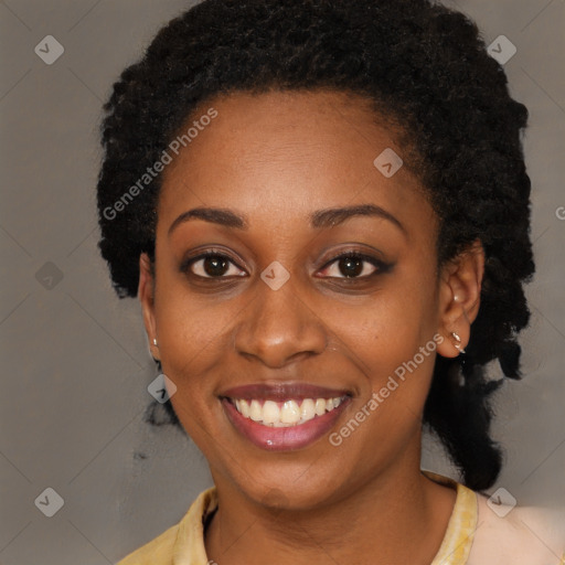 Joyful black young-adult female with long  black hair and brown eyes