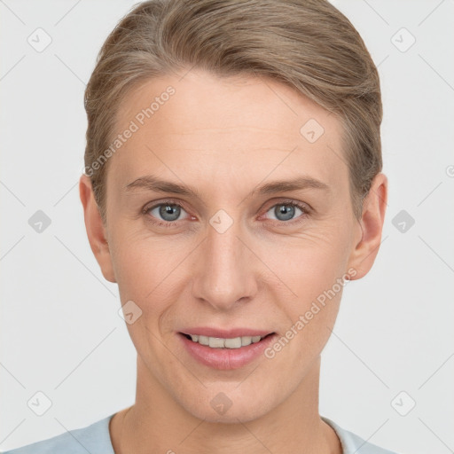 Joyful white adult female with short  brown hair and grey eyes