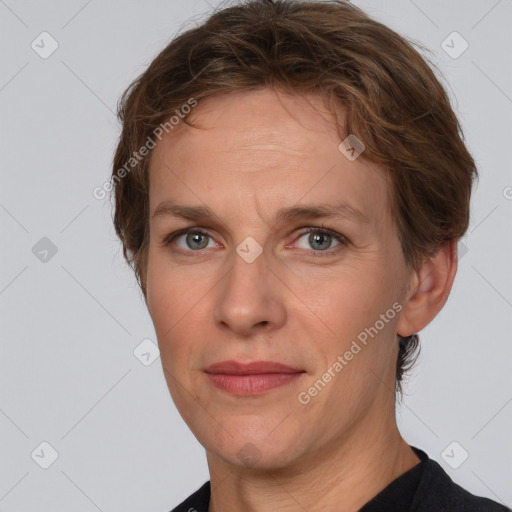 Joyful white adult female with short  brown hair and grey eyes