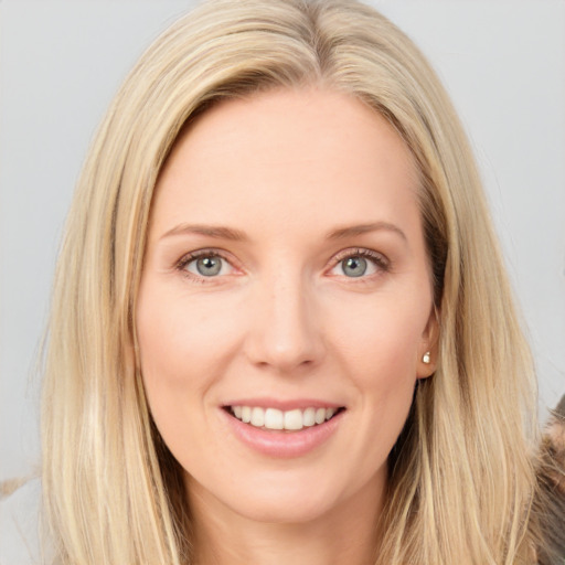 Joyful white young-adult female with long  brown hair and blue eyes