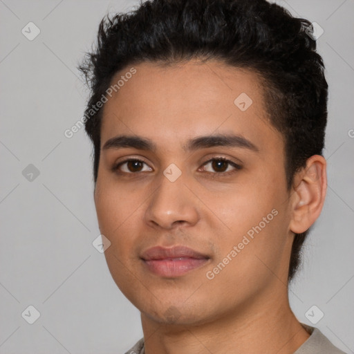 Joyful latino young-adult male with short  black hair and brown eyes