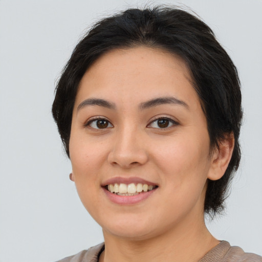 Joyful asian young-adult female with medium  brown hair and brown eyes