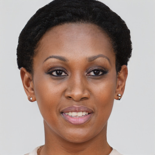 Joyful black young-adult female with short  brown hair and brown eyes