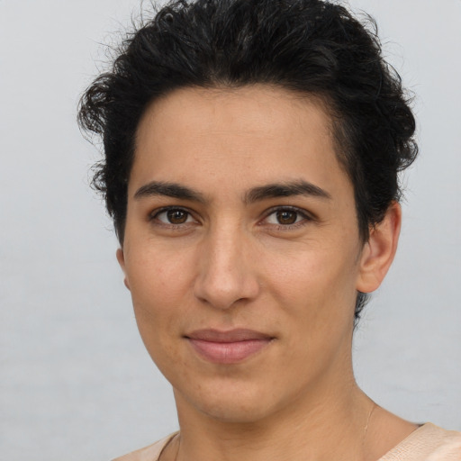 Joyful latino young-adult female with short  brown hair and brown eyes
