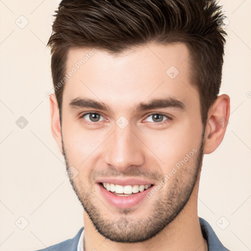 Joyful white young-adult male with short  brown hair and brown eyes