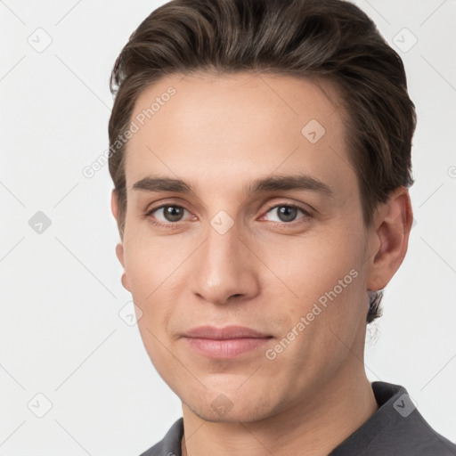 Joyful white young-adult male with short  brown hair and grey eyes