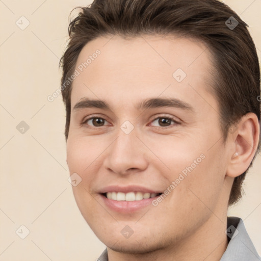 Joyful white young-adult male with short  brown hair and brown eyes