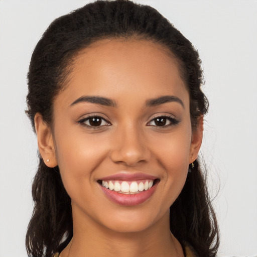 Joyful latino young-adult female with long  brown hair and brown eyes