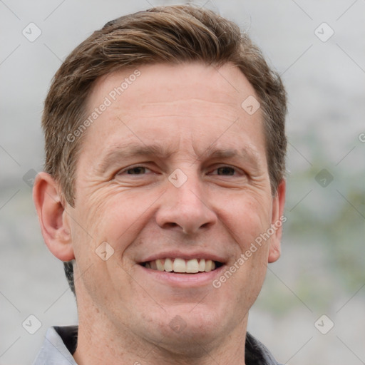 Joyful white adult male with short  brown hair and grey eyes