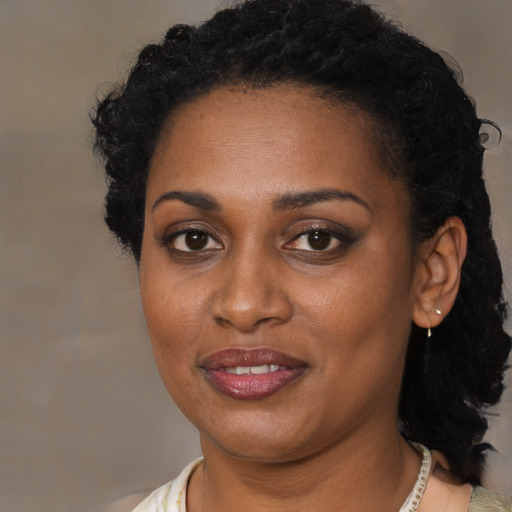 Joyful black young-adult female with medium  brown hair and brown eyes