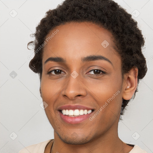 Joyful black young-adult female with short  brown hair and brown eyes