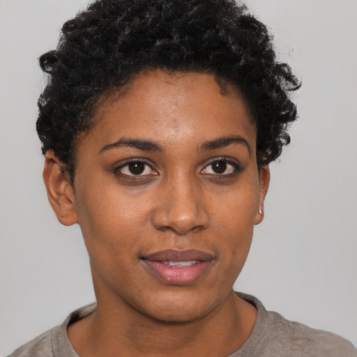 Joyful black young-adult female with short  brown hair and brown eyes