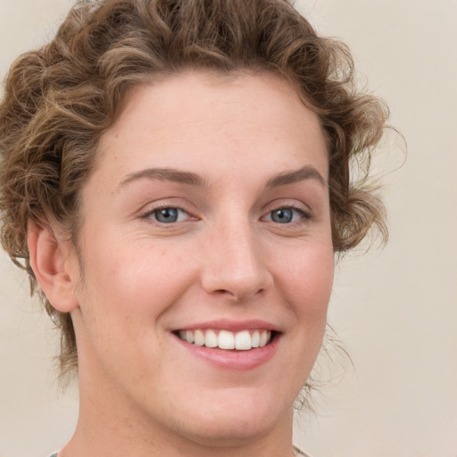 Joyful white young-adult female with medium  brown hair and green eyes