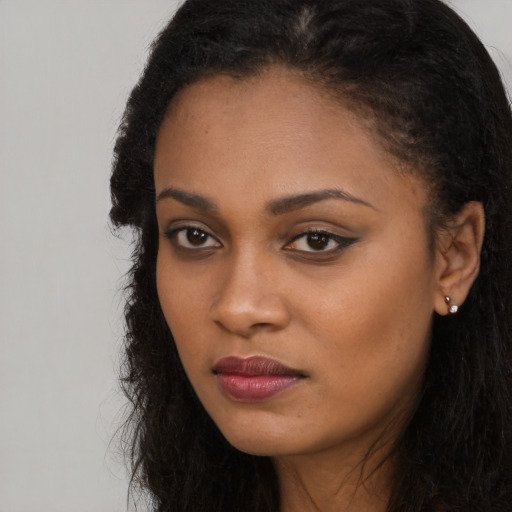 Neutral black young-adult female with long  black hair and brown eyes