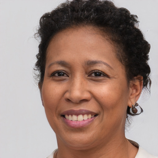 Joyful black adult female with short  brown hair and brown eyes