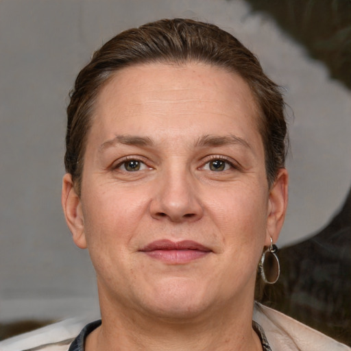 Joyful white adult female with short  brown hair and brown eyes